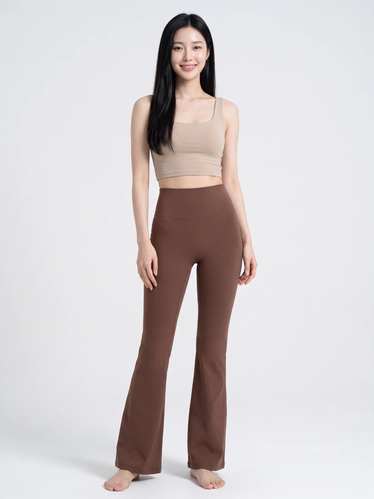 Chestnut brown high-waisted flared yoga pants worn with a beige crop top, standing front view