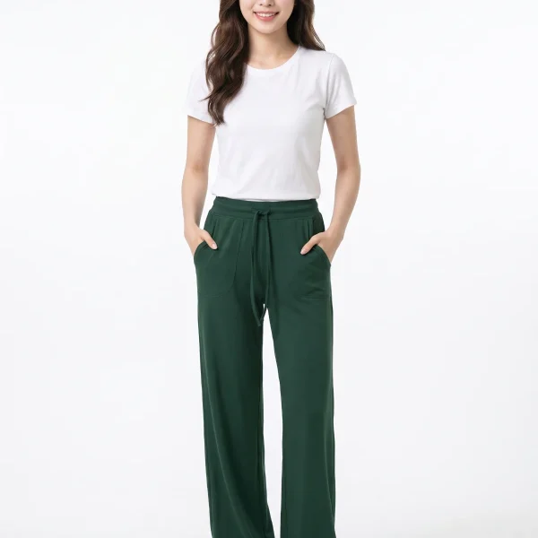 Model wearing dark green wide-leg yoga pants with hands in pockets